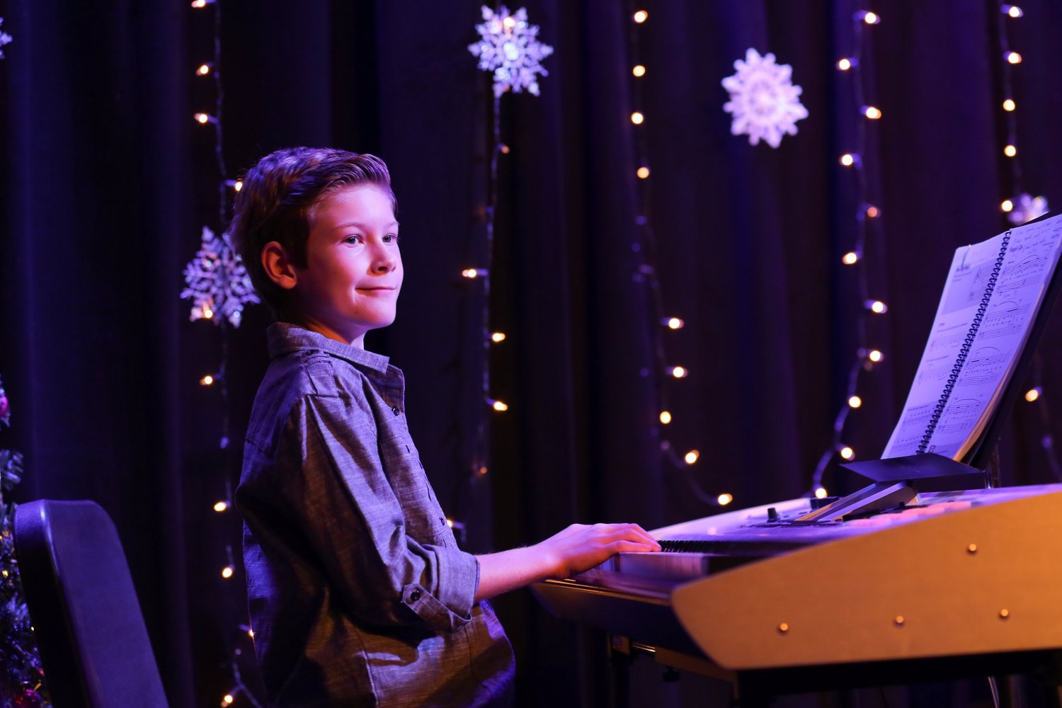 Student playing piano at a recital